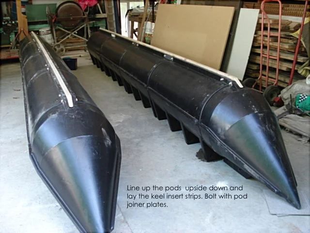 Black Main Boat Pods lined up upside down with keel insert strips fitted
