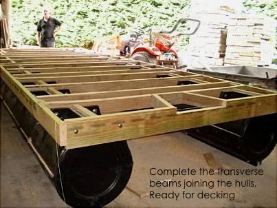 Twin pod hulls joined by transverse timber beams, ready for decking