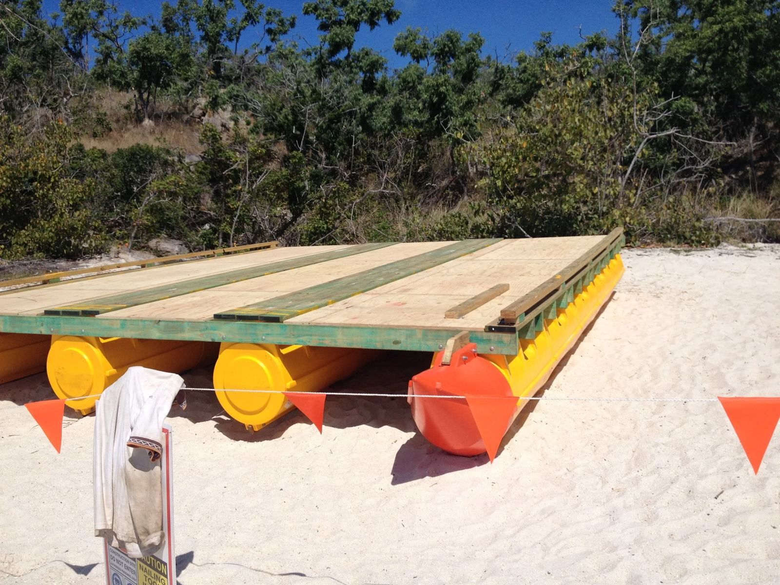 Multi-hull digger barge on pods on a sandy beach