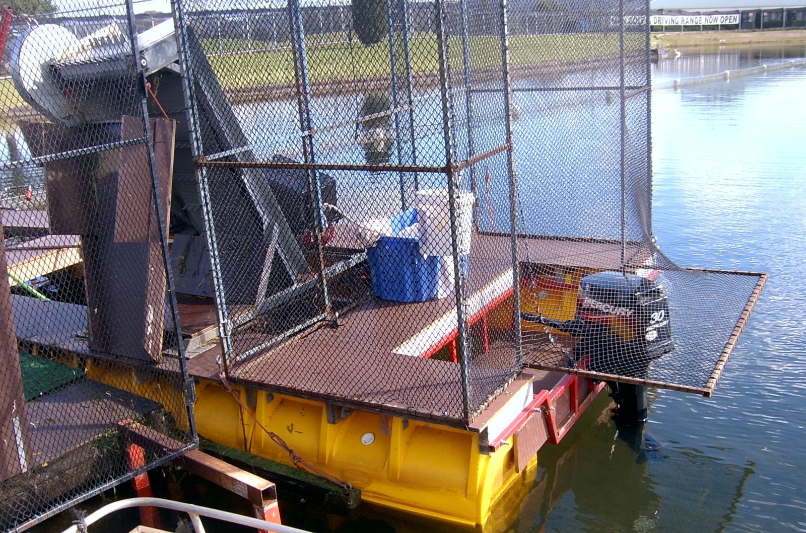 Fishing boat on pods with mesh cage