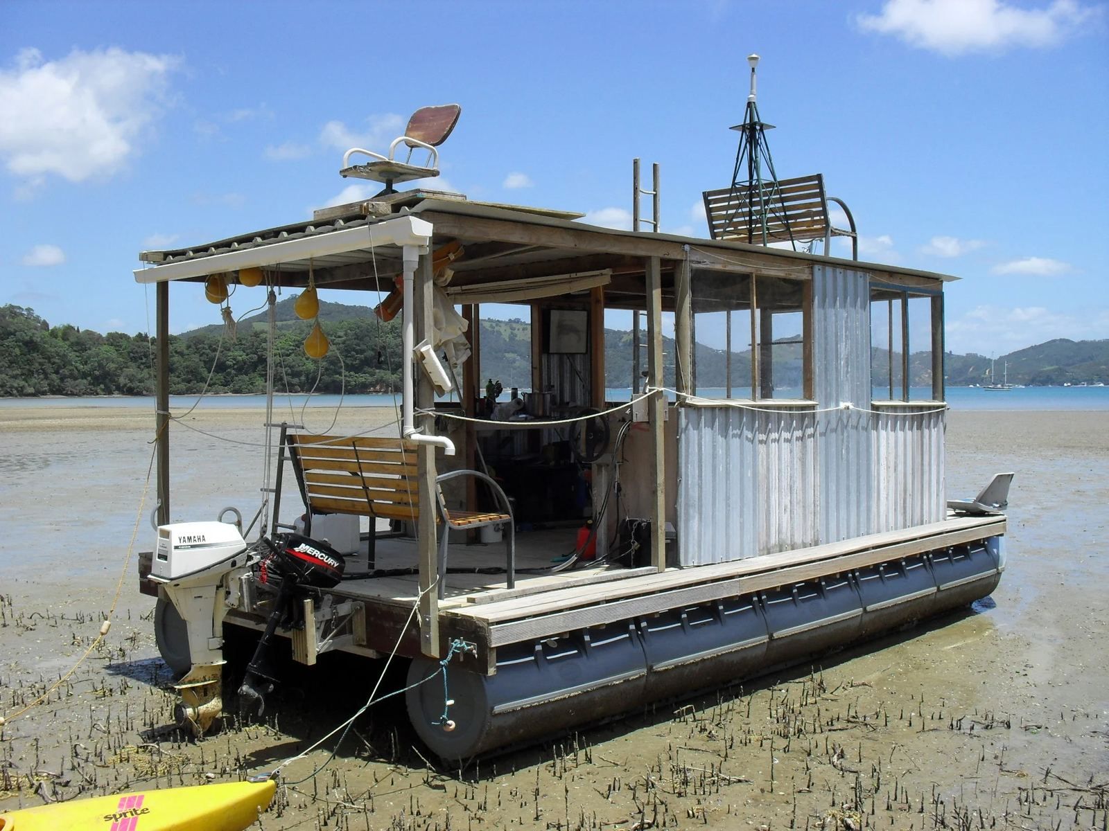Houseboat with timber cabin and outboard