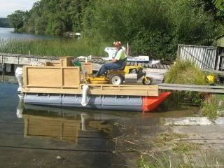Mower driving onto a pod barge