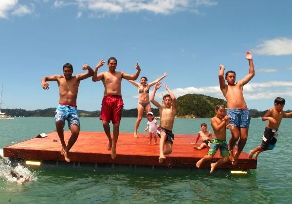 Kids jumping off the Paihia community swim raft built on Pontoonz pods
