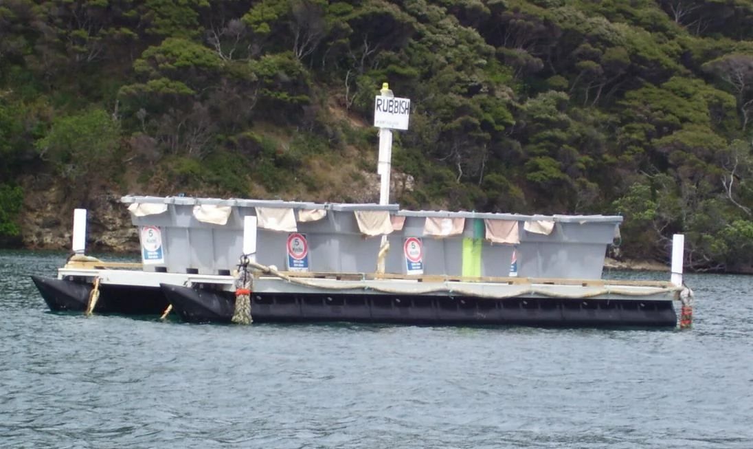 Rubbish barge with bins on deck
