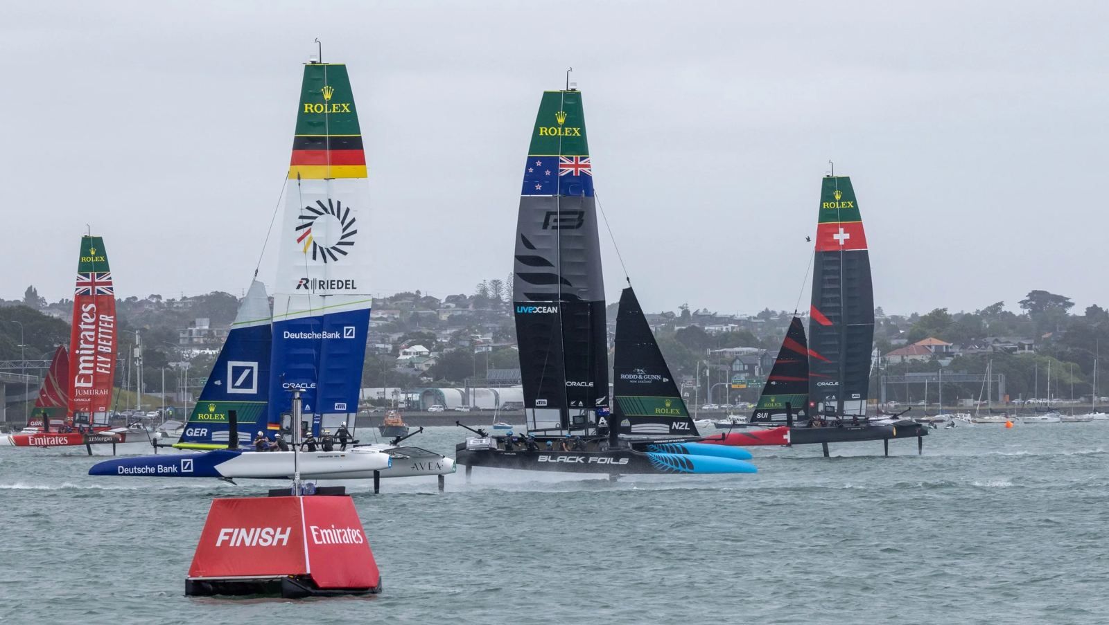 SailGP F50 fleet racing past a Pontoonz marker boat
