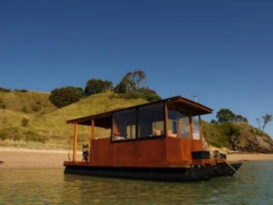 Timber-clad houseboat on pods