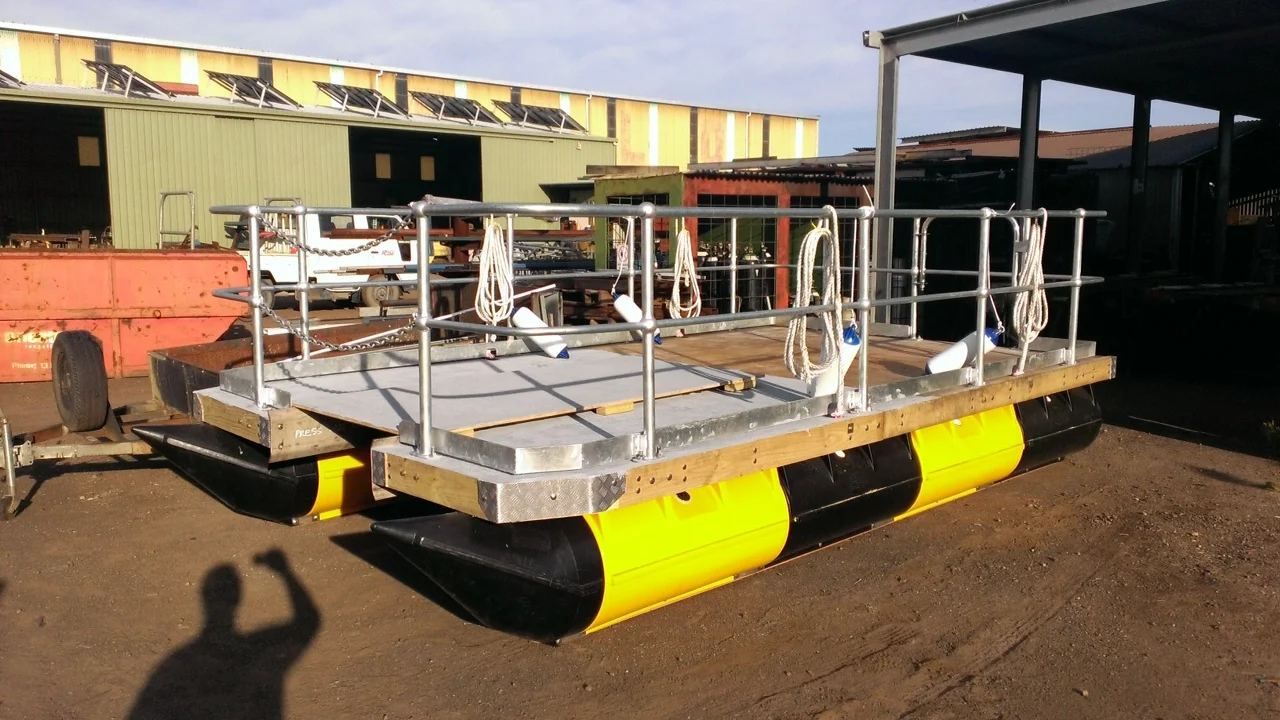 Work barge with steel railings